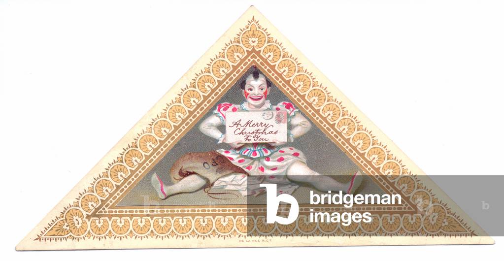 Victorian triangle shaped Christmas card of a clown sitting on the floor and holding a Christmas message, c.1880 (colour litho)
