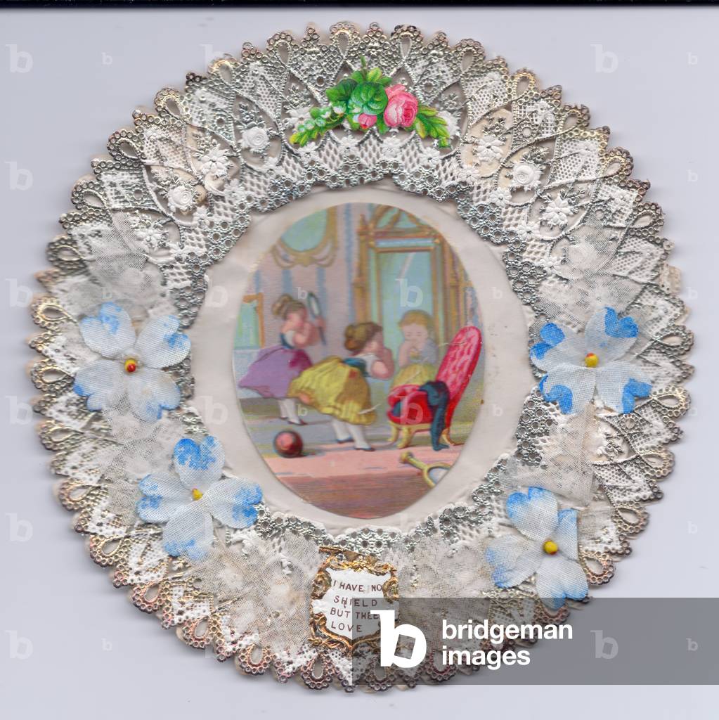A Victorian heavily embossed paper lace oval greeting card with fabric flowers and two girls dressing up in a room full of mirrors, c.1880 (colour litho)