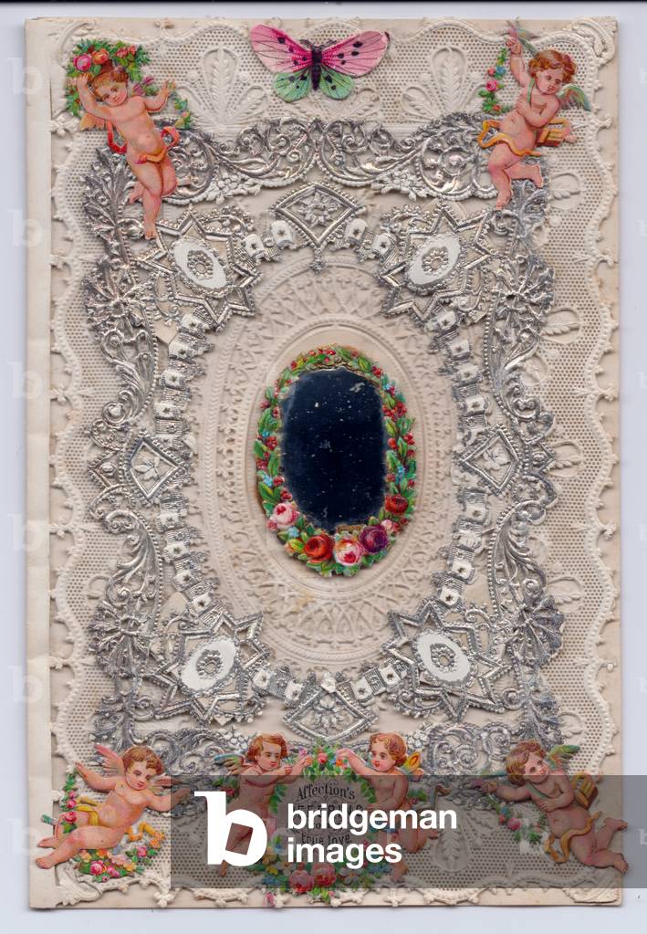 A Victorian silver embossed paper lace greeting card of a mirror surrounded by a wreath of flowers and paper scraps of cupids, c.1880 (colour litho)