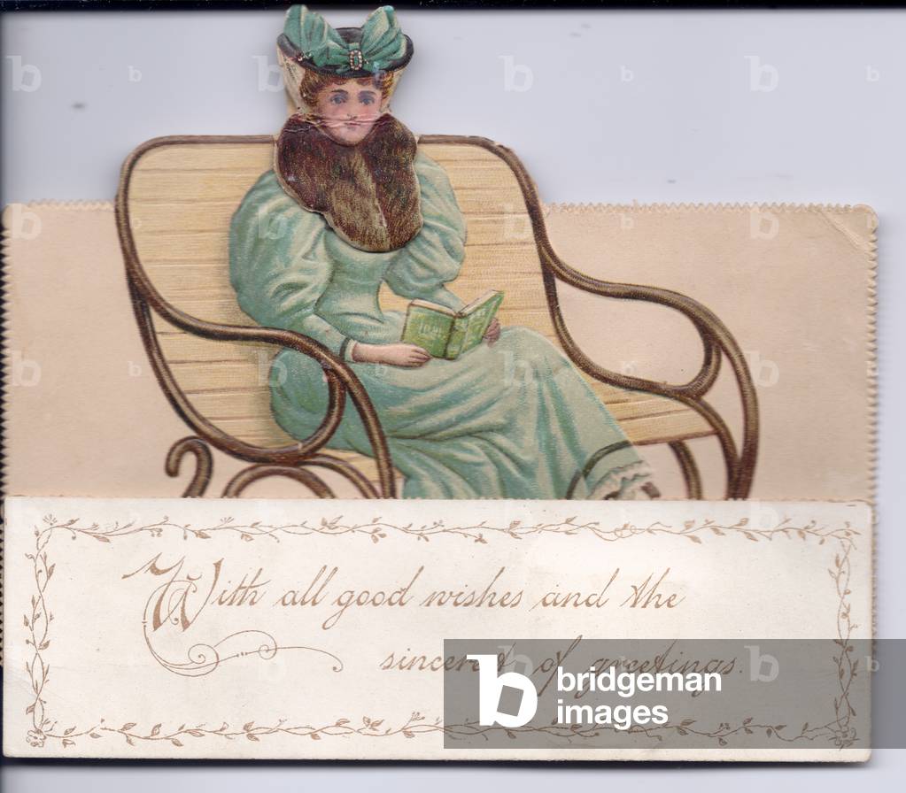 A Victorian die cut mechanical greeting card of a woman with a fur collar and wearing a veiled hat sitting on a chair holding a book, c.1880 (colour litho)