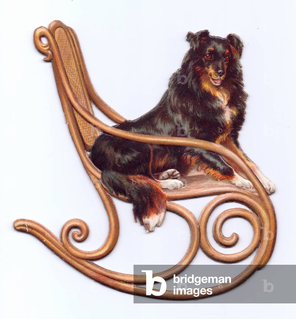 A Victorian Die-cut shape card of a dog sitting in a rocking chair, c.1880 (colour litho)