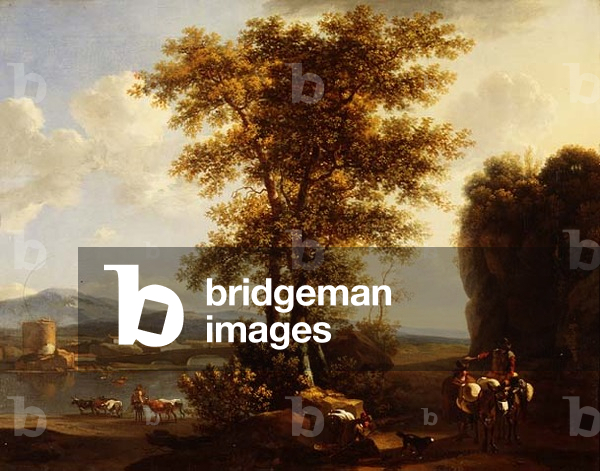 An Italianate wooded river landscape with travellers on a path, a herdsman with cattle & a town beyond
