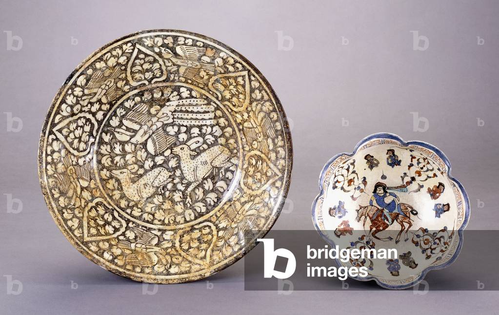 A Sultanabad pottery dish, depicting two seated deer amongst dense leafy motifs, 14th century (ceramic)