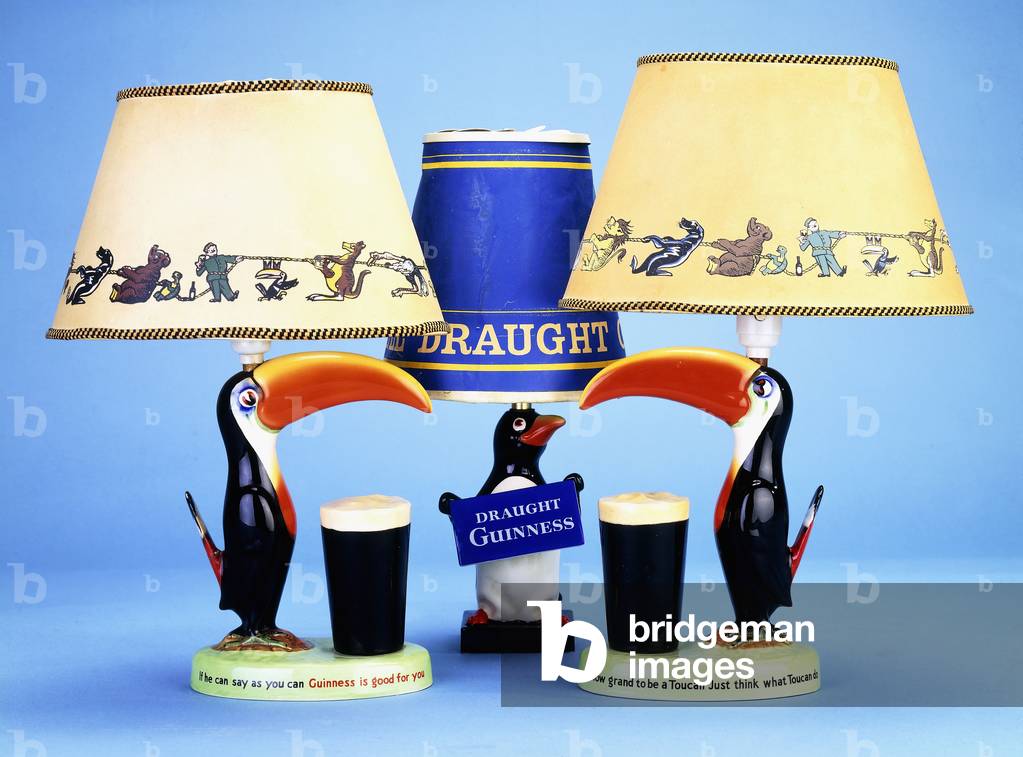 A lampbase modelled as a toucan beside a pint glass,  (carltonware painted in colours)