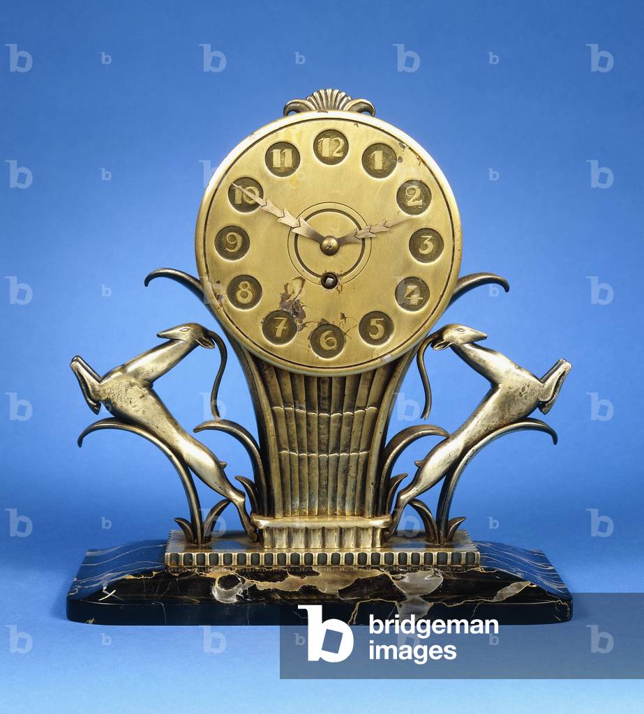 A bronze mantel clock with two leaping gazelles (bronze, black striated marble base)