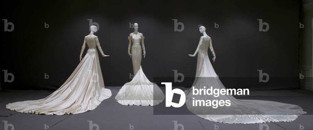 Wedding gown, 1950 (silk satin, Antonio Canovas del Castillo for Elizabeth Arden, New York), wedding dress, 1934 (silk satin, lace, rhinestones, pearls, Madame Marguerite, Chicago), and wedding gown and halo, 1938 (silk satin, Tappe, New York)