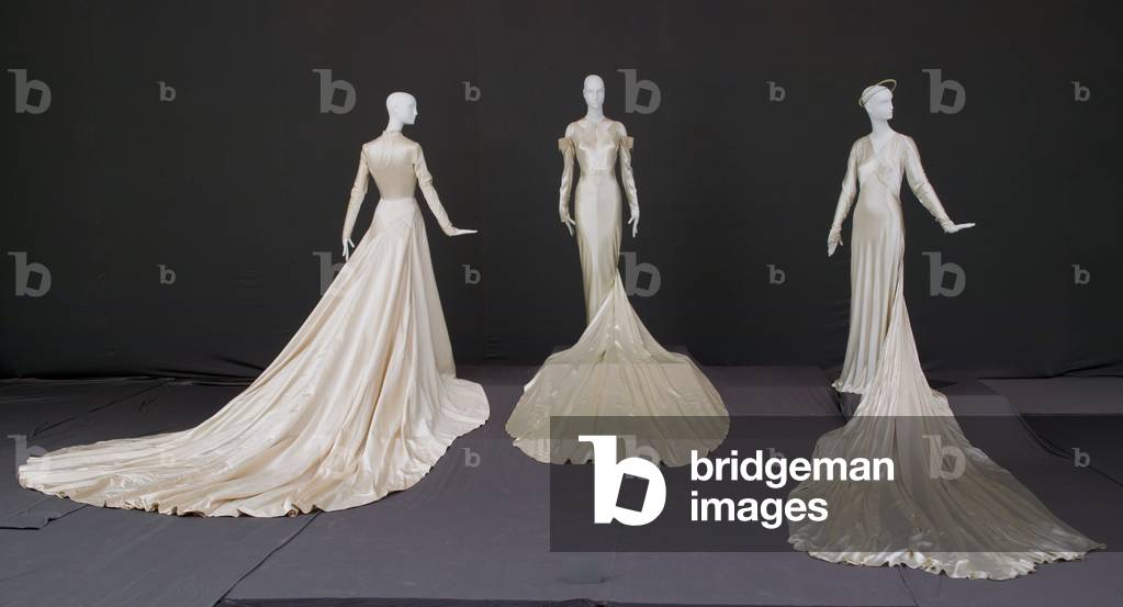 Wedding gown, 1950 (silk satin, Antonio Canovas del Castillo for Elizabeth Arden, New York), wedding dress, 1934 (silk satin, lace, rhinestones, pearls, Madame Marguerite, Chicago), and wedding gown and halo, 1938 (silk satin, Tappe, New York)