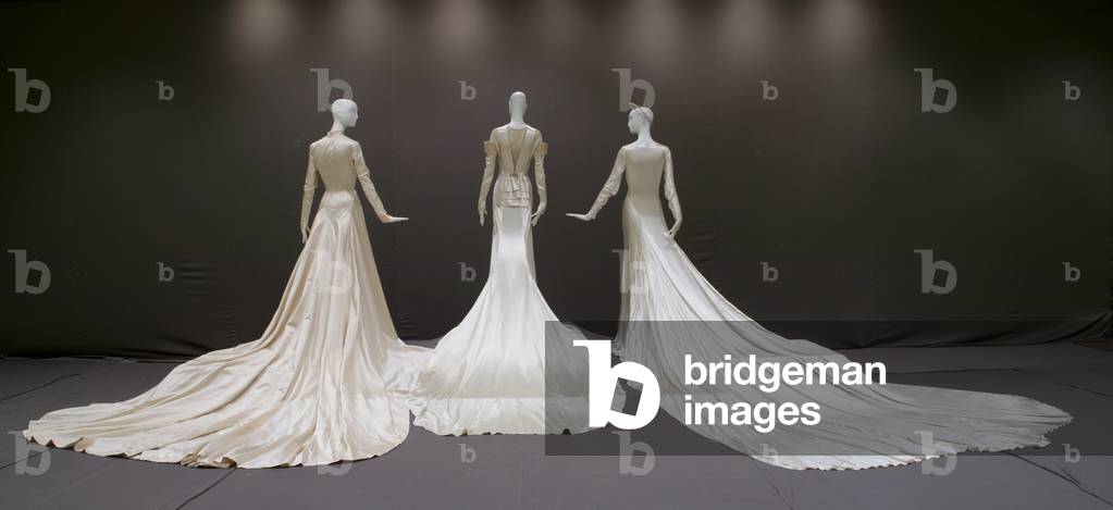 Wedding gown, 1950 (silk satin, Antonio Canovas del Castillo for Elizabeth Arden, New York), wedding dress, 1934 (silk satin, lace, rhinestones, pearls, Madame Marguerite, Chicago), and wedding gown and halo, 1938 (silk satin, Tappe, New York)