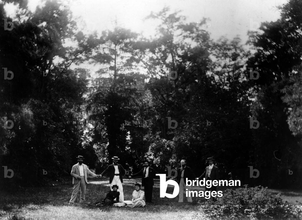 Group of friends holding hands in the garden of 'Le Relais', home of the Natanson family in Villeneuve-sur-Yonne, c. 1899 (b/w photo)