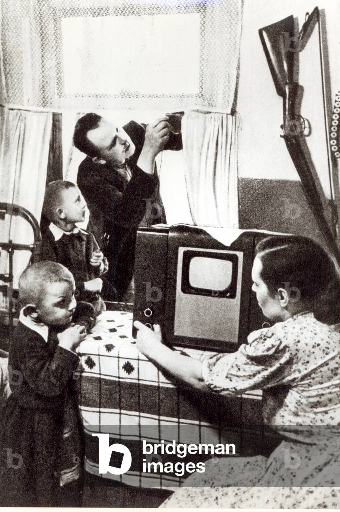 Installation of a new television in the home of a Soviet family, 1954 (b/w photo)