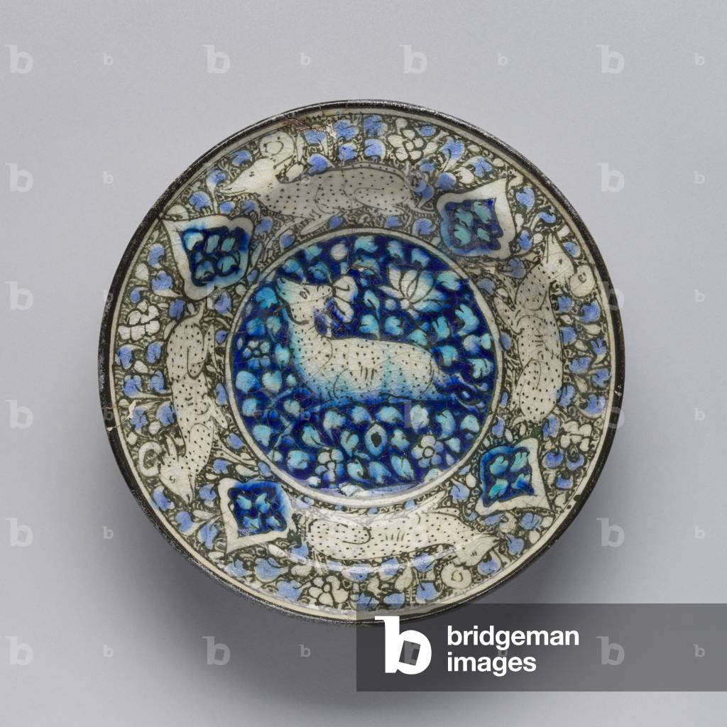 Dish with running quadrupeds, Sultanabad ware, Iran, Ilkhanid period, first half of 14th century (earthenware with underglaze painting in blue, black, turquoise) 