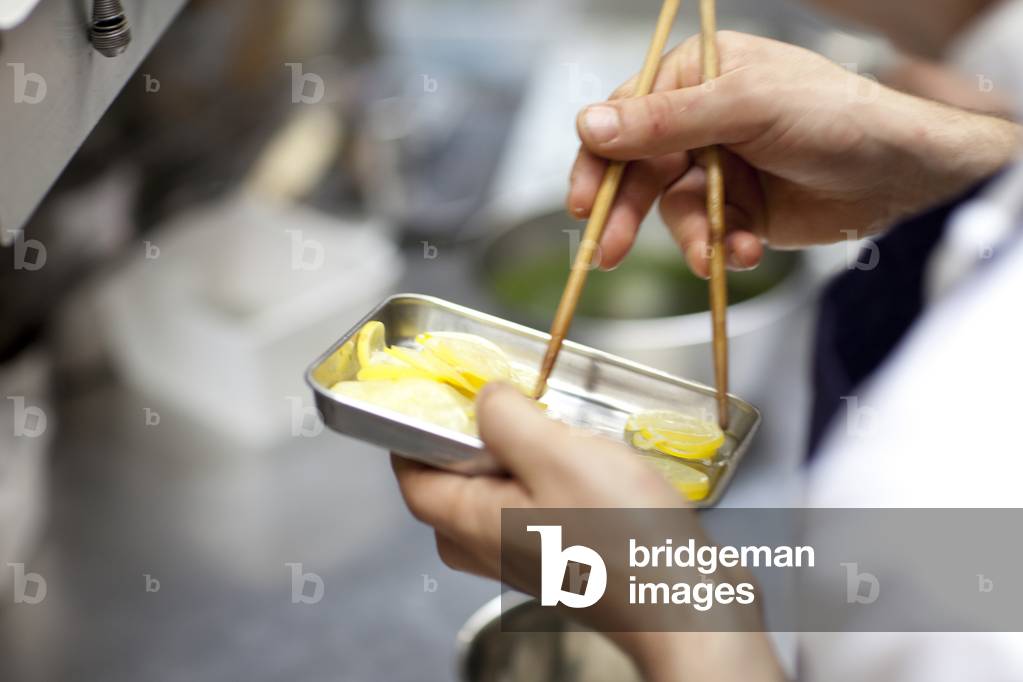 Chef preparing garnishes, restaurant kitchen, Paris, France (photo)