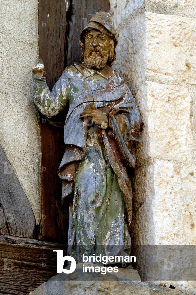 Ancient statue on the walls of a half-timbered house of the 15th century in Walnut sur Serein (Yonne)