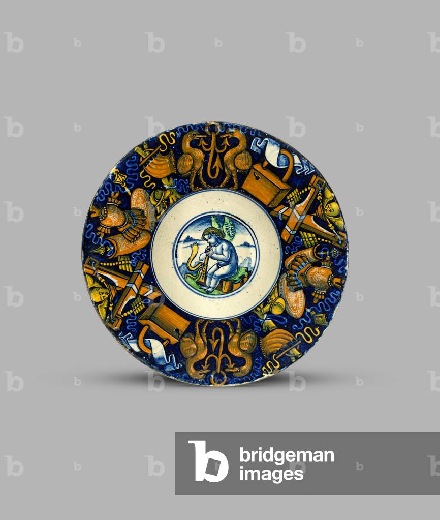 Dish or tondino with a putto playing a wind instrument (centre) 
and border of trophies
, c.1515 (tin-glazed earthenware (maiolica))