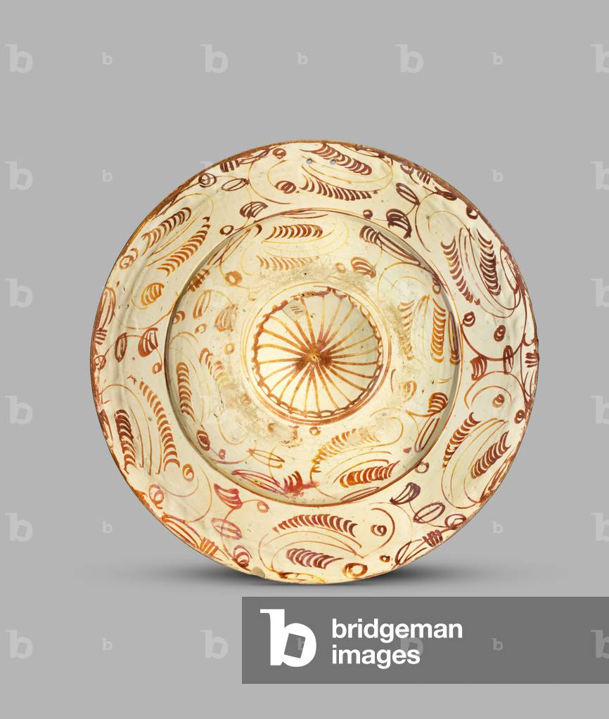 Dish decorated in lustre with raised boss of concentric rings, 1500-25 (tin-glazed lustred ceramic)