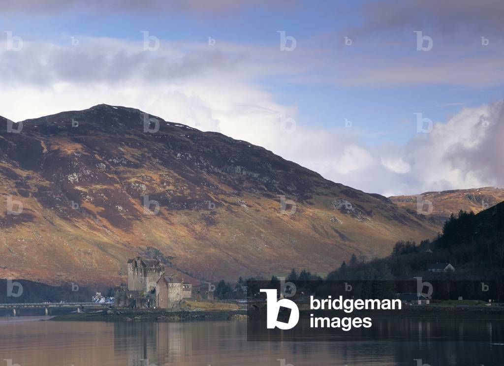 Eilean Donan castle, built in 13th century, reflected in the calm water of Loch Duich from Totaig, Dornie, Highland region, Scotland, United Kingdom, Europe