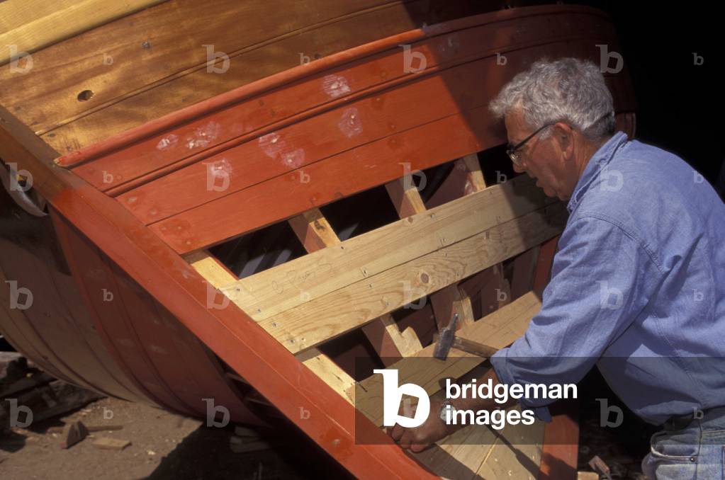 Craftsman working at “” Bilancelle”” boat, St Pietro island, Sardinia, Italy