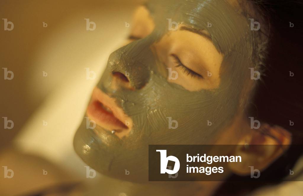 Woman takes a mud bath treatment, Rapolano, Tuscany, Italy