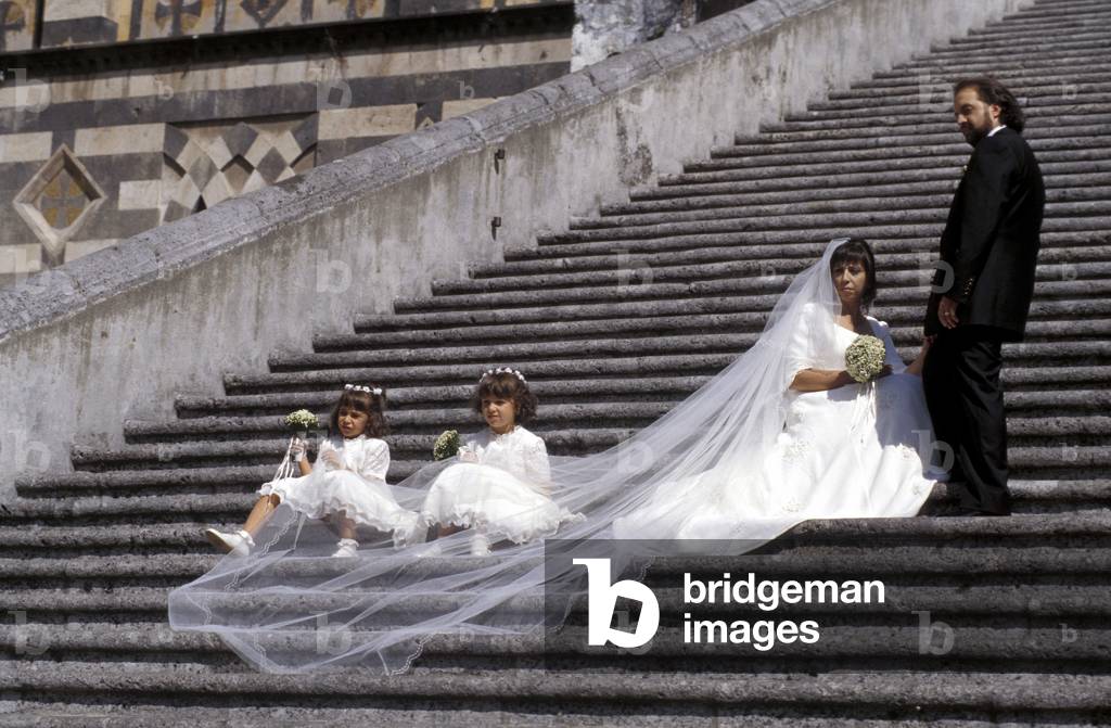 Newlywed couple on the Duomo's steps, Amalfi, Campania, Italy