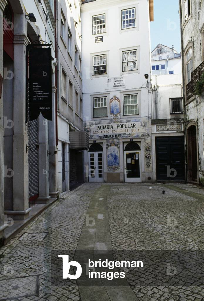 Buildings on Largo de Freira, with bakery decorated with azulejo tiles in the foreground, Coimbra, Centro, Portugal