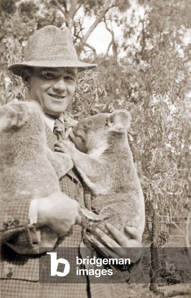 Visitor holding Koalas at Taronga Zoo, Sydney, Australia. 1932 (b/w photo)