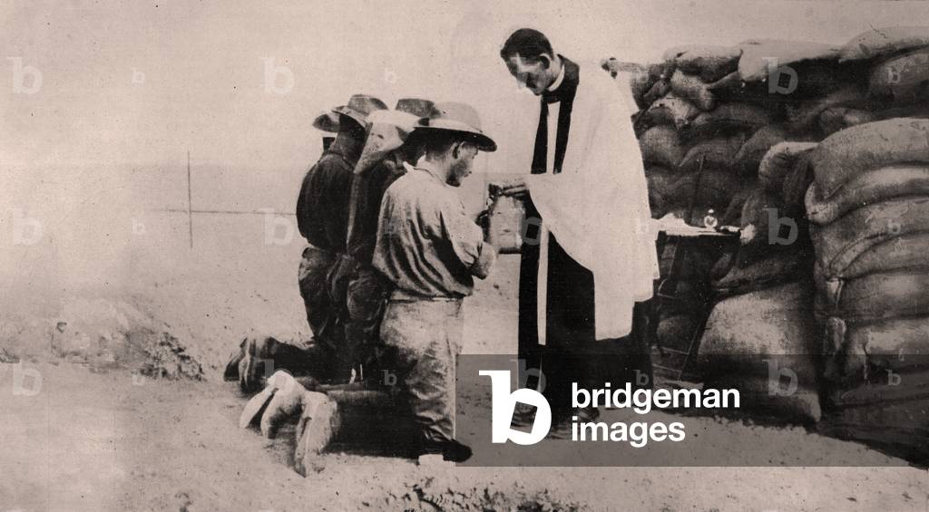At an Altar backed by Sand-bags at a block-house, a Priest offers Communion, South west Africa, 1915 (photo)