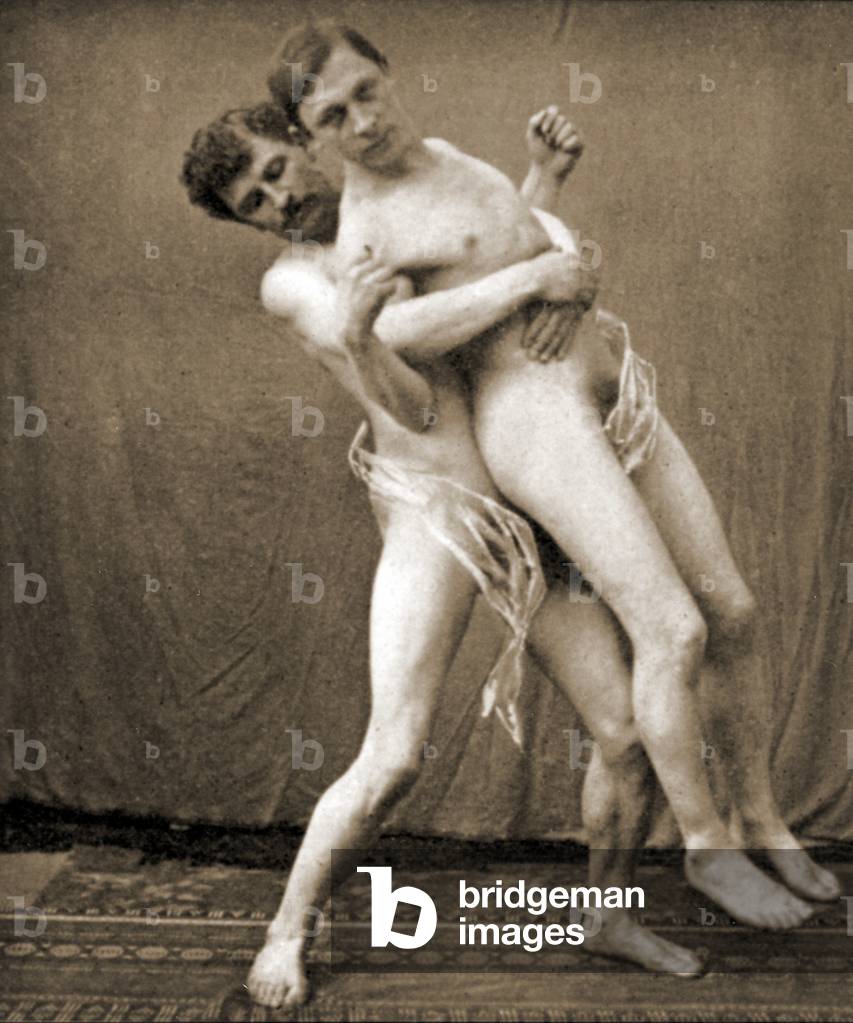 Wrestlers demonstrate the waist hold, c.1910 (sepia photo)
