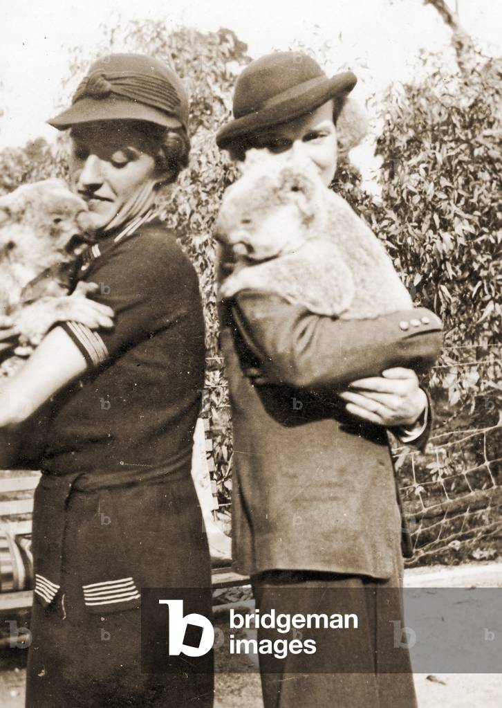 Visitors holding Koalas at Taronga Zoo, Sydney, Australia. 1932 (b/w photo)