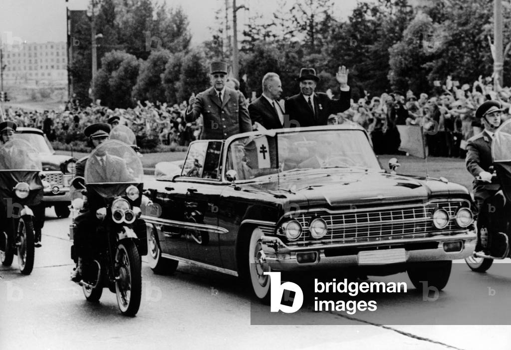 General de Gaulle, Nikolai Podgorny, Chairman of the Presidium of the Supreme Soviet of the Soviet Union, and Alexei Kosygin leave the Moscow Aerodrome, 20 June 1966 (b/w photo)
