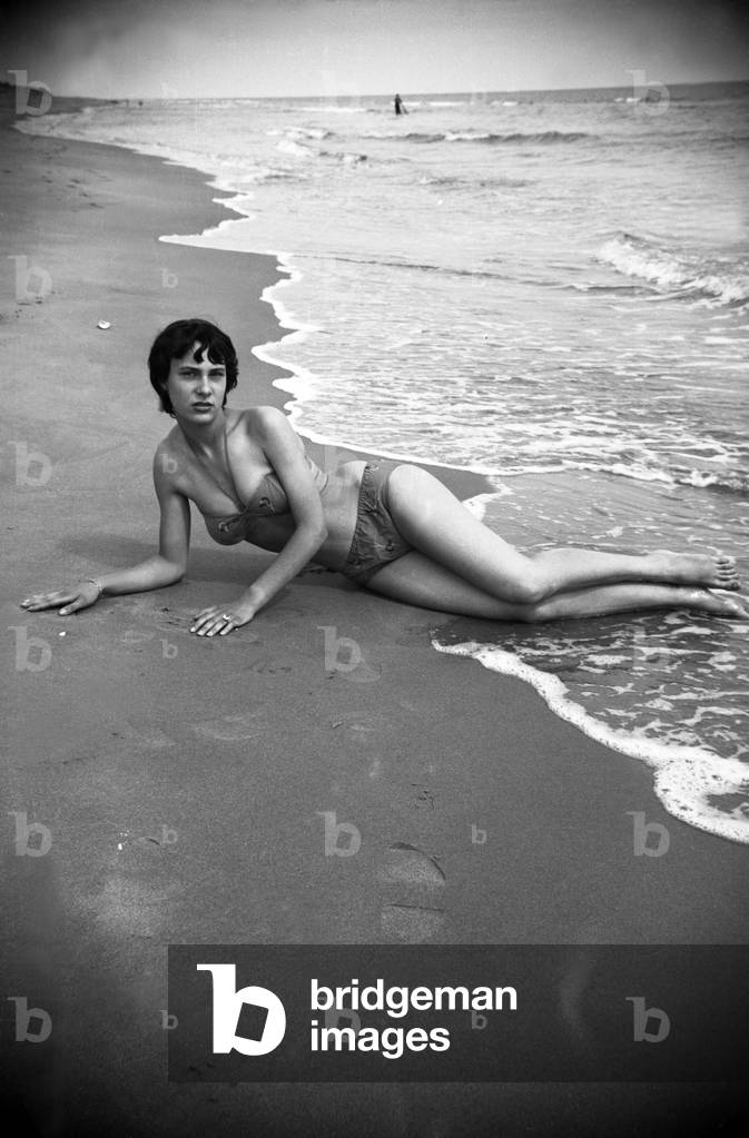 Bernadette Lafont, as a young woman, on the beach, south of France, c. 1955 (b/w photo)