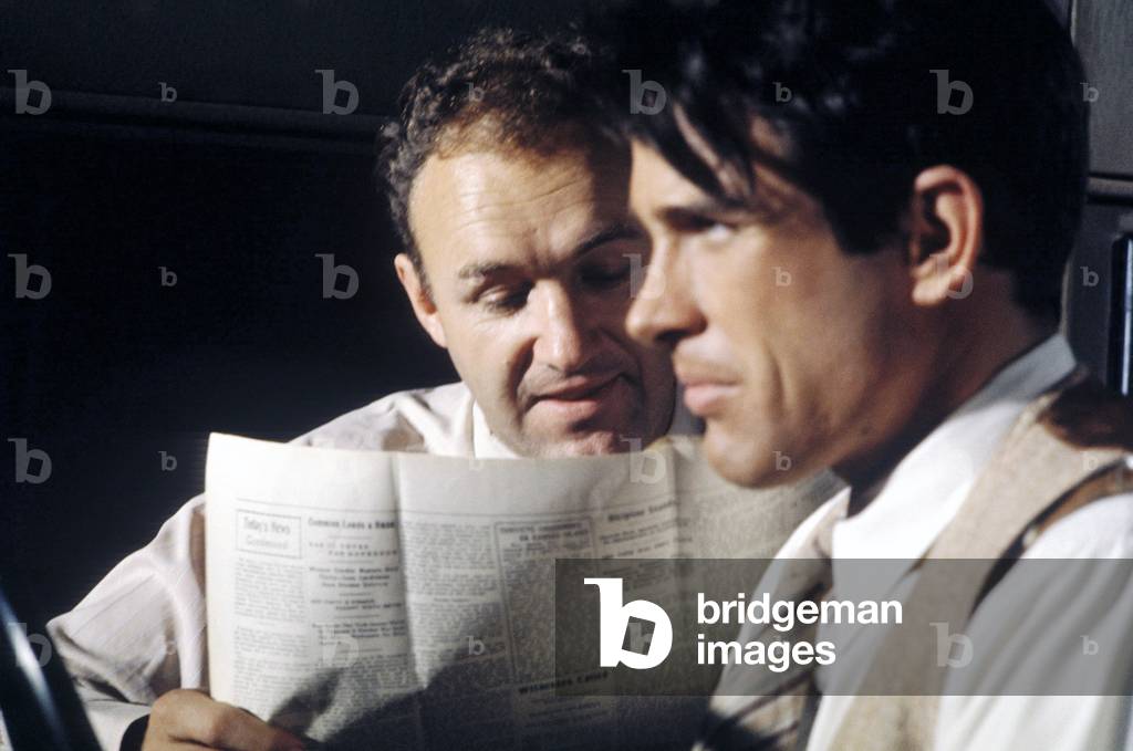 Medium Shot Of Gene Hackman As Buck Barrow Reading Newspaper While Warren Beatty As Clyde Barrow Drives Car, Bonnie And Clyde 1967 Directed By Arthur Penn