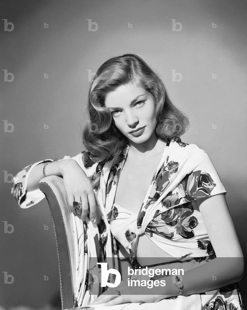 American Screen Star Lauren Bacall Wearing A Summer Suit In A Bold Floral Print.