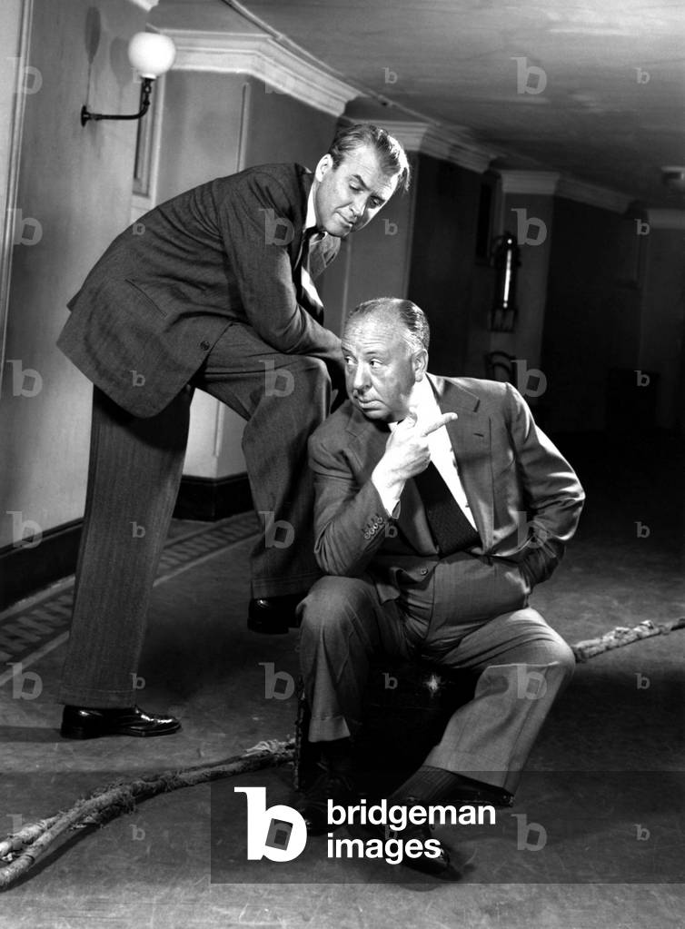 Director Alfred Hitchcock (1899 - 1980) posing with actor James Stewart (1908 - 1997), who starred in several of his films (b/w photo)