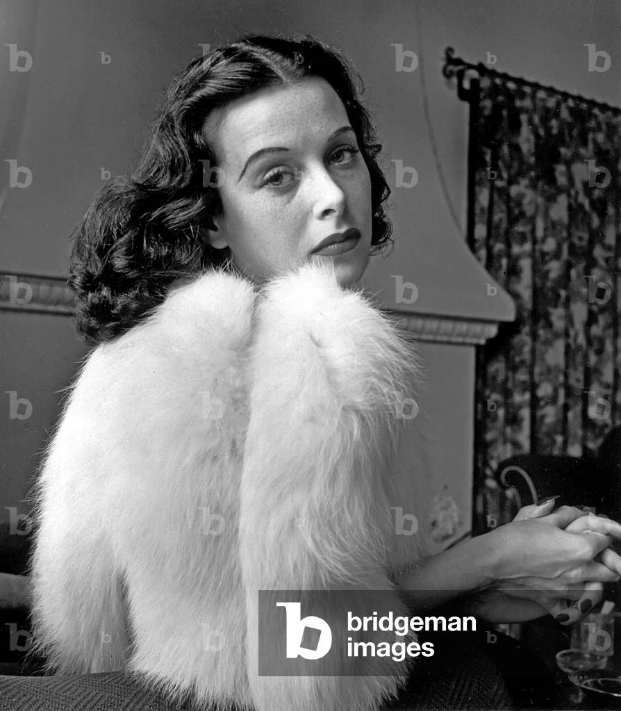 Glamorous portrait of movie actress Hedy Lamarr wearing white fox fur short jacket., 1938 (b/w photo)