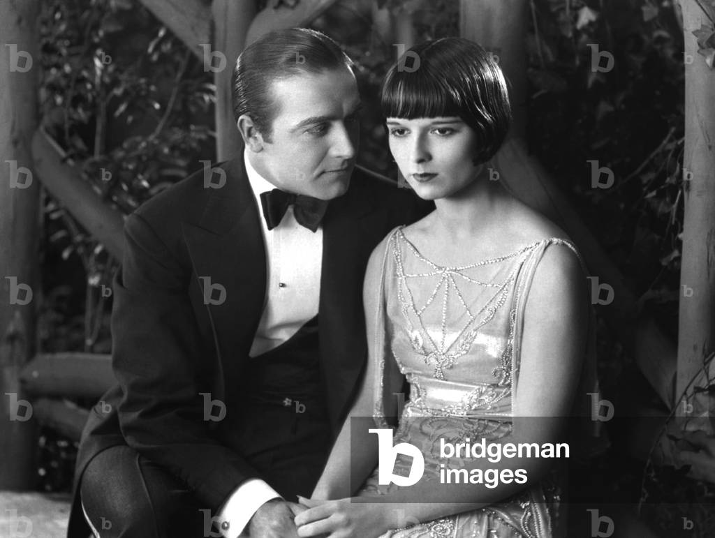 Circa 1925: American Actress Louise Brooks (1906-1985) Shares A Romantic Arbour With A Man In A Scene From An Unknown Film.