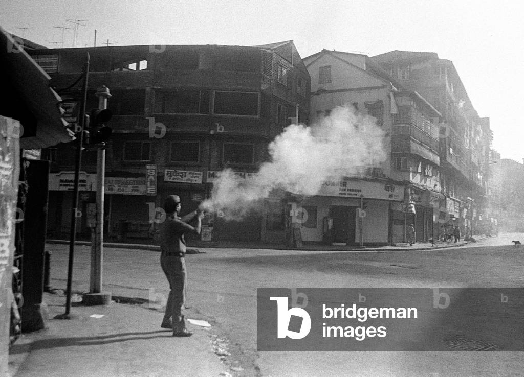 Police fire tear gas on rioters after religious fundamentalists demolished the Babri Masjid, Ayodhya, Uttar Pradesh, India, 6th December 1992 (b/w photo)