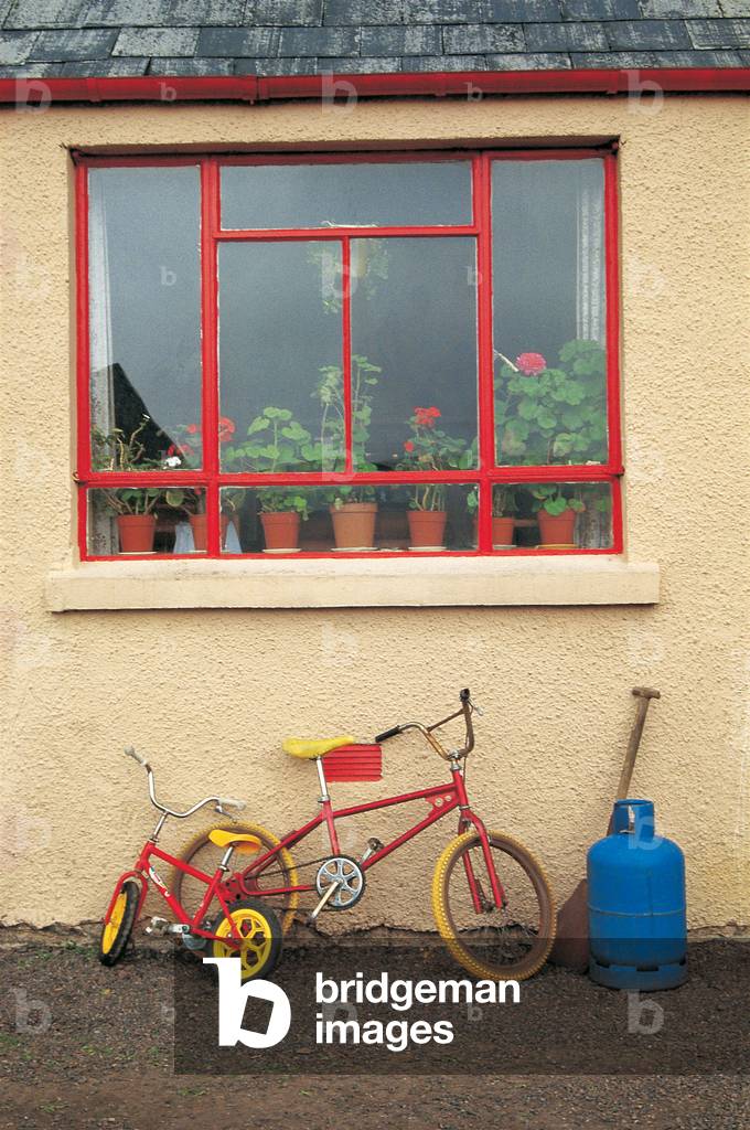 Bicycles below a window, Scotland (photo)