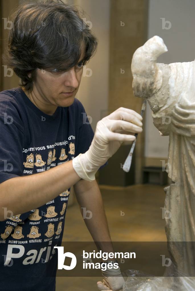 Archaeologist carrying out restoration work on an artefact at Beirut's National Museum, Beirut, Lebanon (photo)