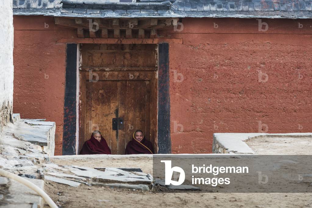 Monks resting and laughing at Labrang Monastery, Tibet, China (photo)