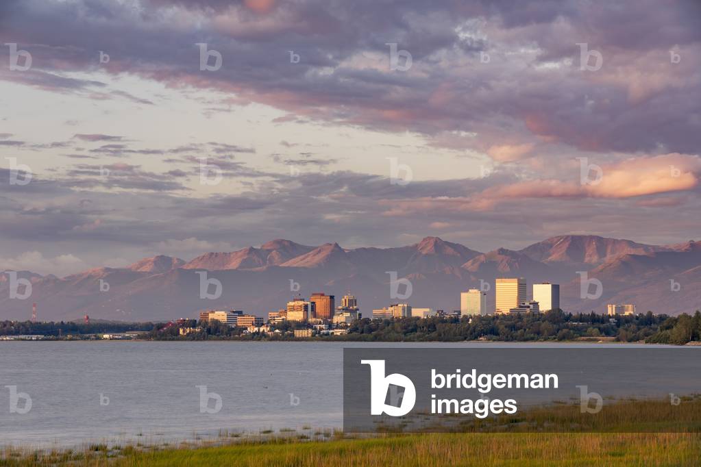 View of downtown Anchorage during an atmospheric sunset as seen from Earthquake Park, Anchorage, Southcentral Alaska, USA, Summer (photo)