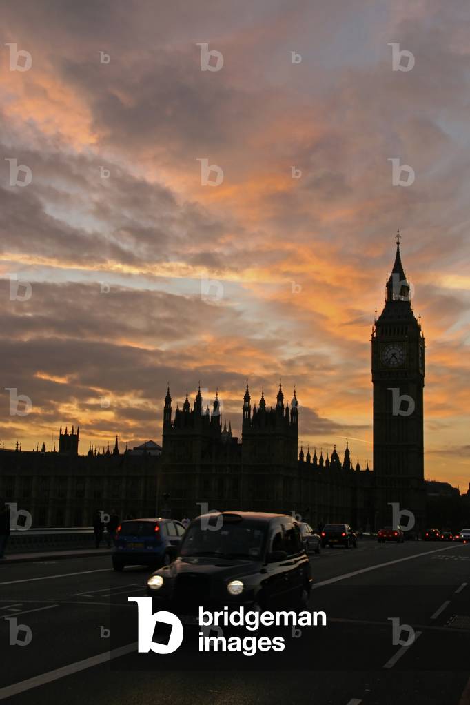Black cab cutside The Houses of Parliament at dusk, London, England, UK (photo)