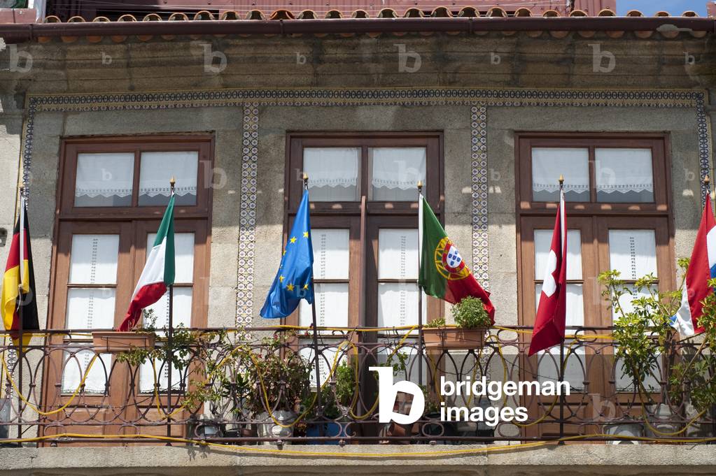 Flags in some hostel balcony, Porto, Portugal (photo)