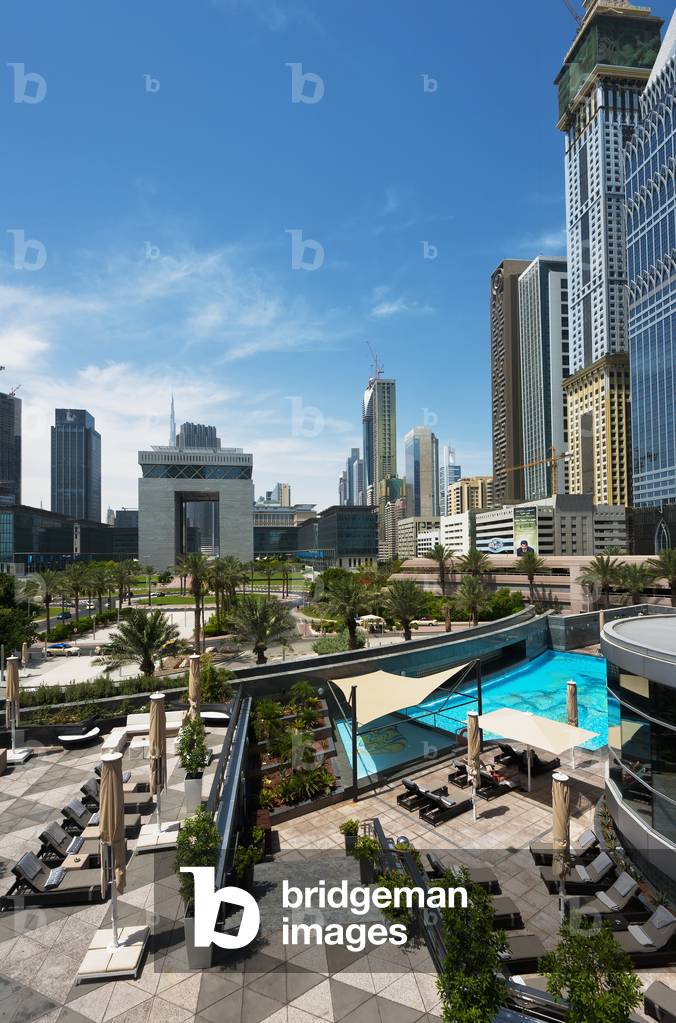Looking Across Hotel Swimming Pool To Difc (Dubai International Financial Centre), Dubai, United Arab Emirates (photo)