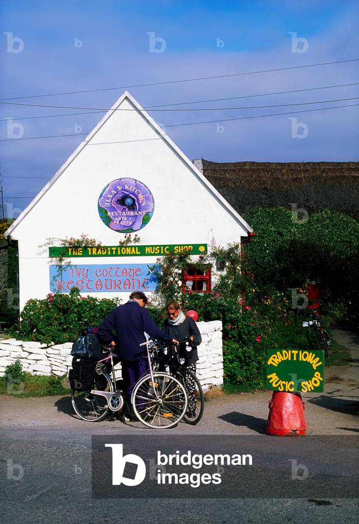Doolin Village,Co Clare,Ireland;Couple Outside A Traditional Music Shop (photo)