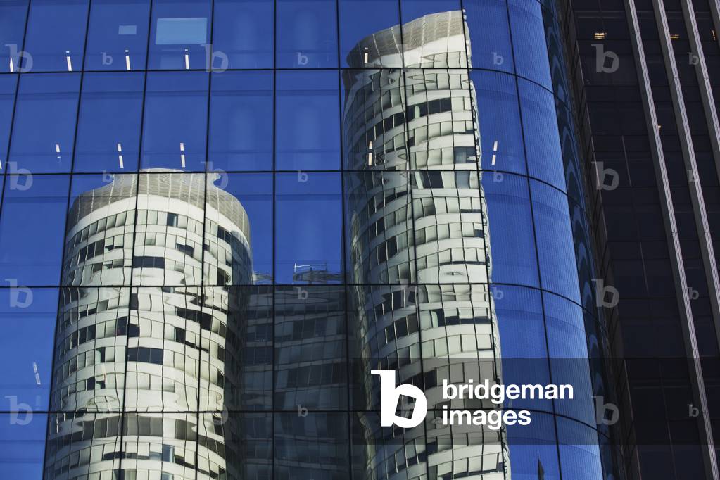 Reflection of a residential building in windows of an office tower, Paris, France (photo)