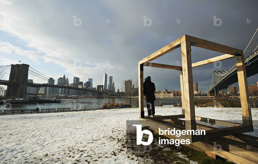 Man and public sculpture in Brooklyn looking towards Manhattan, New York City, New York, USA (photo)