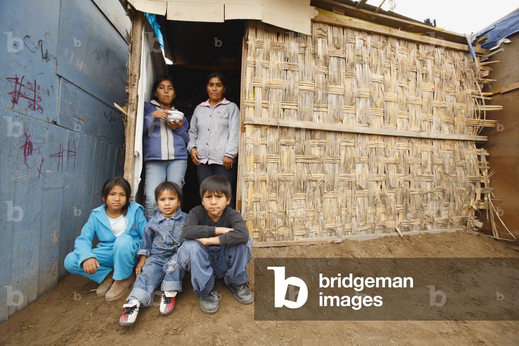 Family Members At Entrance to Slum Dwelling, Lima, Peru (photo)