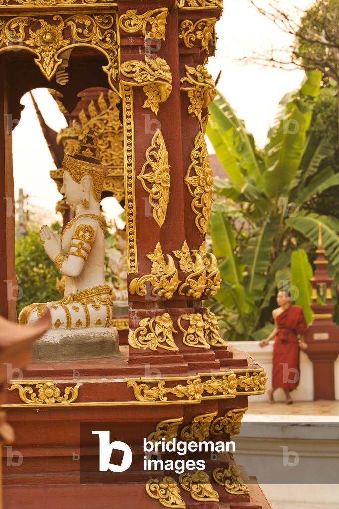 Chiang Mai, Thailand, Buddhist Monk behind a Statue of the Buddha (photo)