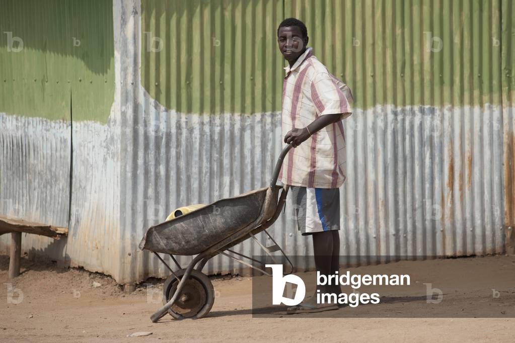 Man with Wheelbarrow, Kenya, Africa (photo)