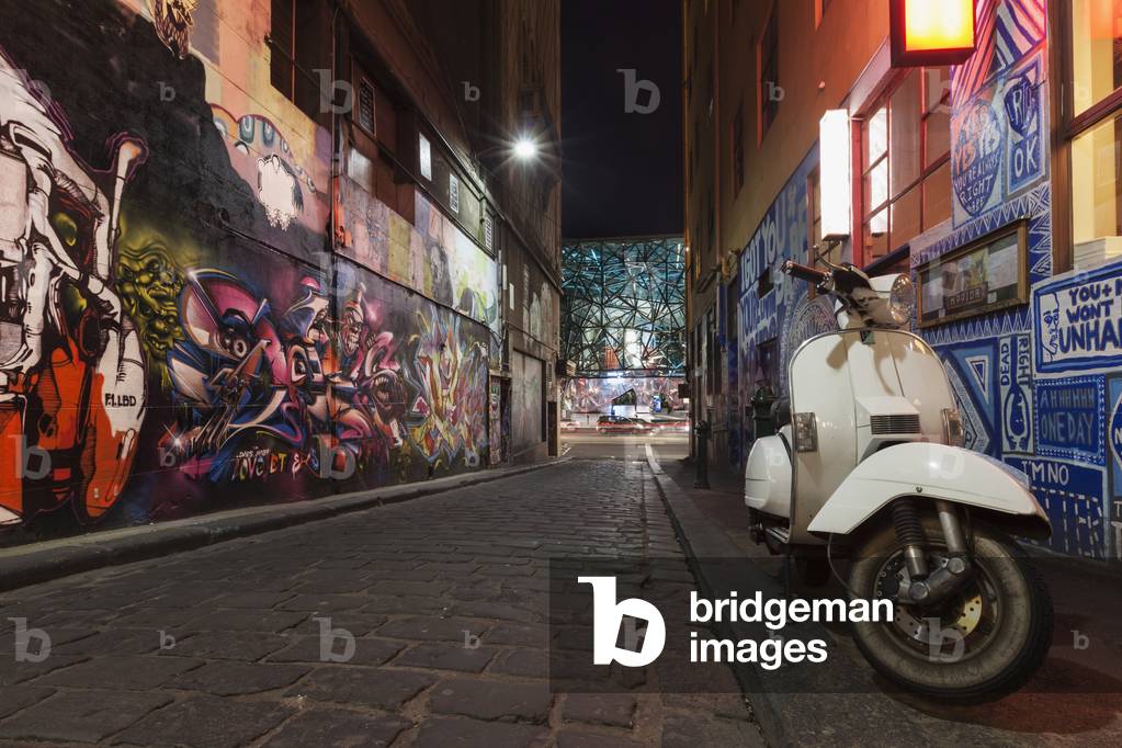 Australia, Victoria, View of street Art and moped on Hosier Lane with Federation Square in background, Melbourne (photo)